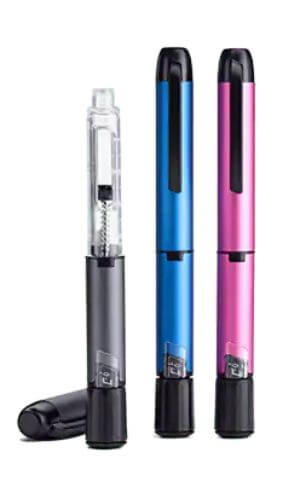 One gray insulin pen with cap off standing beside one blue insulin pen & one pink insulin pen