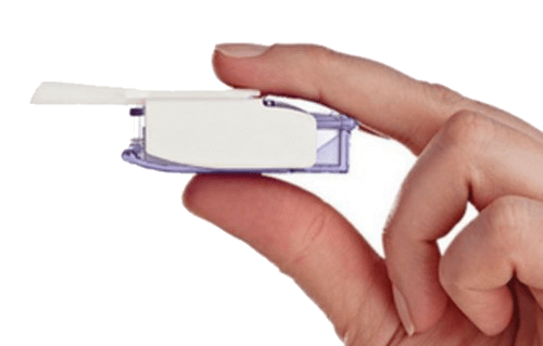 Afrezza insulin inhaler held between an index finger & thumb to show size